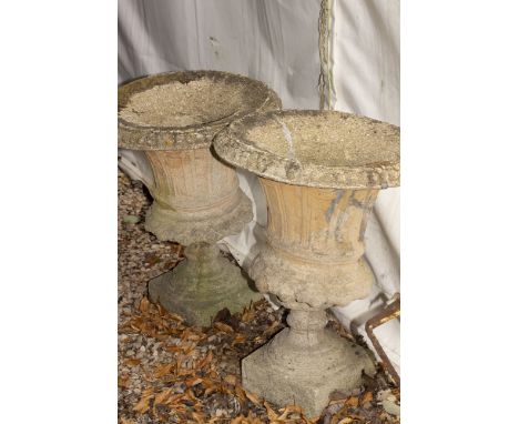 A PAIR OF CAST RECONSTITUTED STONE GARDEN URNS of campana form with fluted bodies and square bases, each approximately 45cm d