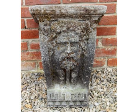 A CAST HADDONSTONE STYLE BRACKET OR FOUNTAIN HEAD decorated with a bearded classical mask and greek key panel, 39cm wide x 32