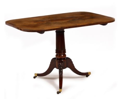 A GEORGE III MAHOGANY TILT TOP TABLE with a turned and reeded stem, tripod base and brass casters, 107cm wide x 73.5cm deep x