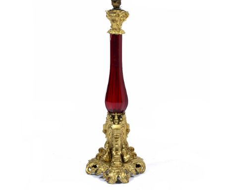 A GILT METAL AND FACETED RED GLASS TABLE LAMP 60cm in height At present, there is no condition report prepared for this lot T