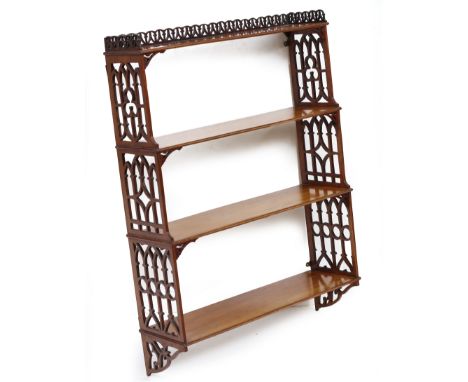 A MAHOGANY FRET CARVED FOUR TIER WALL SHELF 61cm wide x 19cm deep x 85.5cm high At present, there is no condition report prep