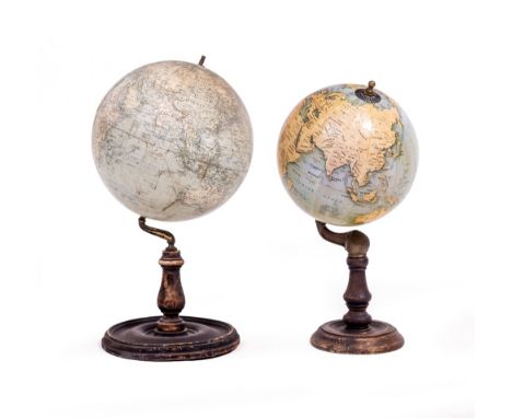 A PHILLIPS EDUCATIONAL TERRESTRIAL GLOBE 20cm diameter and mounted on a turned ebonised base, standing 41cm high overall toge