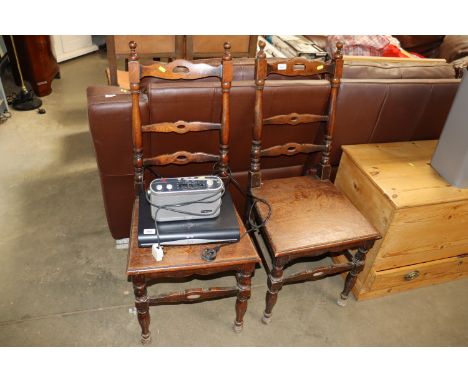 A pair of oak ladder back chairs raised on ring turned supports