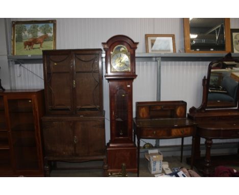 A reproduction mahogany long case clock with chiming movement