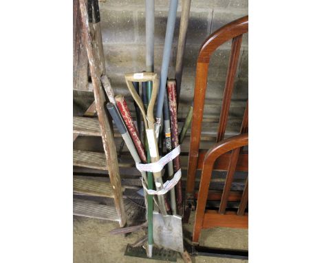 A quantity of long handled garden tools to include shears, spade, rakes etc