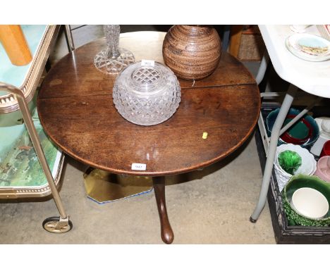 A circular mahogany snap topped table raised on tripod base (adapted)