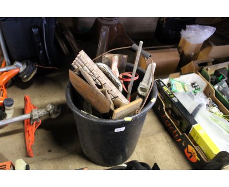 A plastic bucket and contents of plasterers tools and other builders tools 