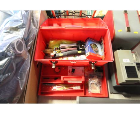 A plastic tool box with contents of various fly fishing material and other fishing equipment 