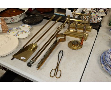 Three brass fire irons; two pairs of fire tongs; chamber stick and a pair of implement rests