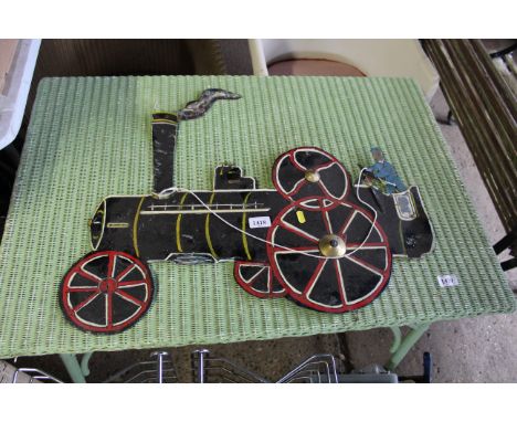 A tin plate sign in the form of a steam engine