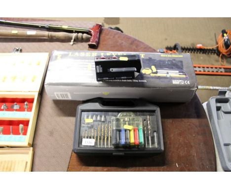 A Constant laser level kit, a Rapitest wire/pipe/ stud detector, a box of various drill bits  and a small case of pocket tool