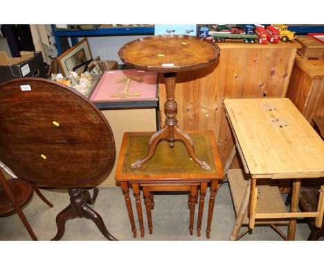 A nest of three reproduction occasional tables and a wine table raised on tripod base