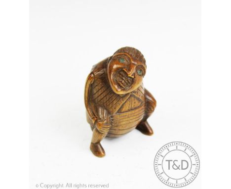A 19th century continental carved treen snuff box, modelled as a defecating man, 7cm CONDITION REPORT: Lightly grubby with li