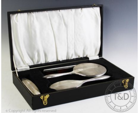 A silver Art Deco dressing table set, W I Broadway &amp; Co, Birmingham 1966, within fitted case  CONDITION REPORT: Comb repl