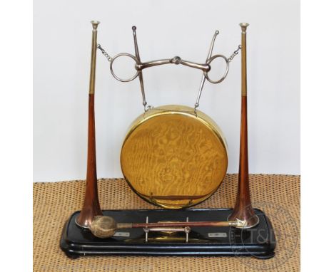A novelty dinner gong formed from two hunting horns stamped for Henry Keat &amp; Sons London, and a horse bit on ebonised bas