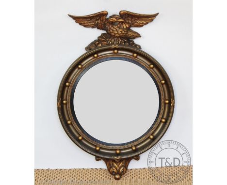 A Regency style gilt wood and composite convex wall mirror, early 20th century, with eagle surmount, 70cm H CONDITION REPORT: