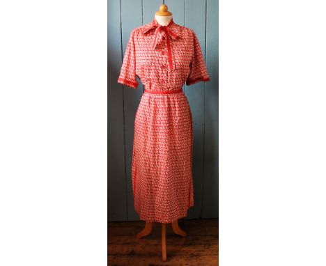 A 1950/60's Christian Dior London, ladies two piece comprising a pussy bow blouse and pencil skirt with red CD monogram again