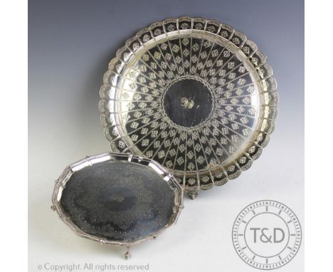A Victorian silver plated salver, possibly Hamilton &amp; Inches, with foliate engraved detailing and scalloped edge, on claw