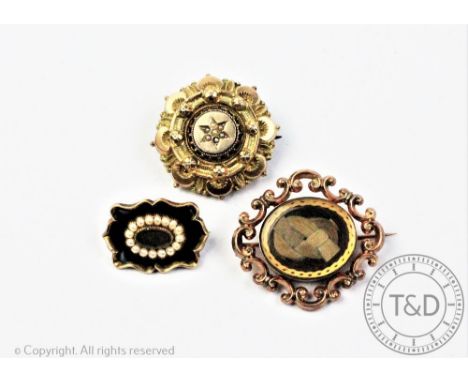 A group of three mourning brooches, comprising, a seed pearl and black enamel example with locket, engraved verso 'Jane Richa