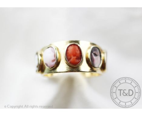 A Victorian cameo set gold ring, the yellow gold band inset with five cameos including mother of pearl, coral and shell, the 