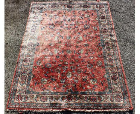A wool carpet, worked with flowers against a red ground, 260cm x 160cm, with another wool rug, 208cm x 307cm (2)Provenance: Y
