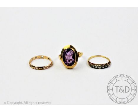 Three rings, to include, a five stone diamond set ring stamped 'D&amp;F 18ct', with an amethyst set dress ring in 9ct yellow 