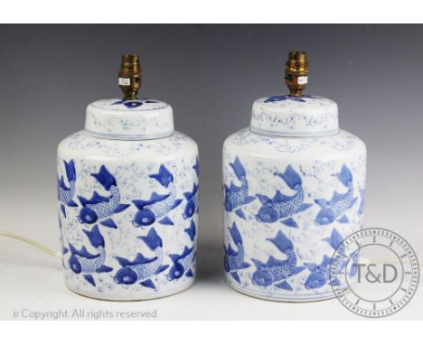 A pair of modern blue and white table lamps, modelled as ginger jars and covers decorated with carp, 32cm highProvenance: Yea