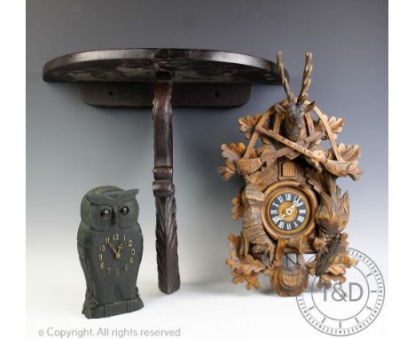 A 20th century German cuckoo clock, with stag surmount and hanging game, with weights and pendulum, 49cm high, a novelty mant