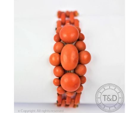 A Victorian coral bracelet, designed as a central lozenge shaped, coral set cluster, upon yellow metal wire frame, and with a