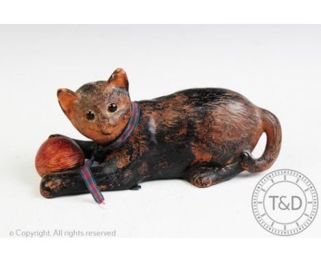 A Bretby Pottery terracotta model of a kitten playing with a ball of string, impressed mark to base, 24cm long