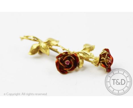 An 18ct yellow gold rose spray and enamelled brooch, designed as two rose flowers with red enamelled detail, naturalistically