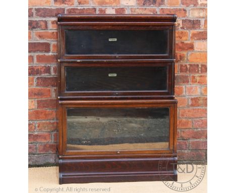 A Globe Wernicke oak three section bookcase, with label to two of the sections, on plinth base, 121.5cm  H x 86.5cm W x 38.5c