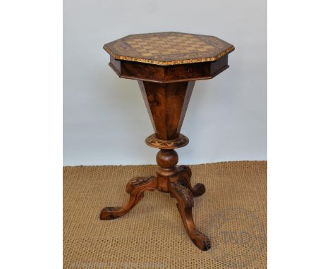 A Victorian inlaid walnut octagonal games table, with hinged lid enclosing a compartmented interior, on carved tripod base, 7