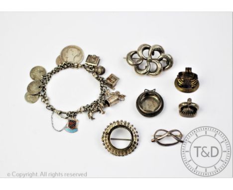 A selection of silver and silver coloured jewellery, to include, a bracelet hung with charms and coins, an intaglio set seal,