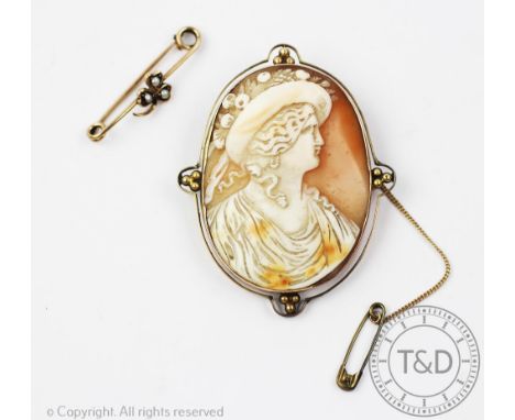 A 9ct gold mounted cameo brooch depicting a female profile wearing a fruit bonnet, 5.5cm overall including mount, with a 9ct 
