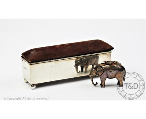 An Edwardian novelty silver elephant pin cushion, Birmingham 1908, 4.5cm long, with a silver ring box / pin cushion, 12cm (2)