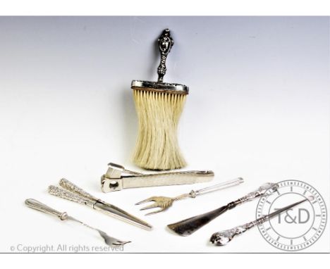 A selection of silver mounted items, comprising; a silver mounted crumb brush, a shoe horn, glove stretchers, a button hook, 