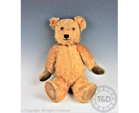 A Chiltern 'Hug-me' bear, golden plush, articulated limbs and rotating head with glass eyes, 46cm 