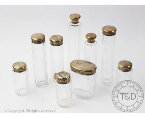 Nine assorted silver topped toilet jars, tallest 18cm, with a French brass carriage time piece, with Roman numeral dial (10)P