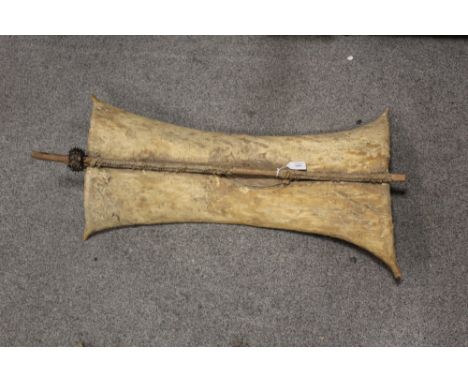 A VINTAGE AFRICAN TRIBAL HIDE AND WOODEN WAR SHIELD,  L 88 cm, average W 28 cm