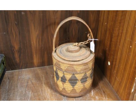 A VINTAGE PAPUA NEW GUINEA MENDI SOUTHERN HIGHLANDS LIDDED BASKET, with handle, woven from bush fibres, H 38 cm