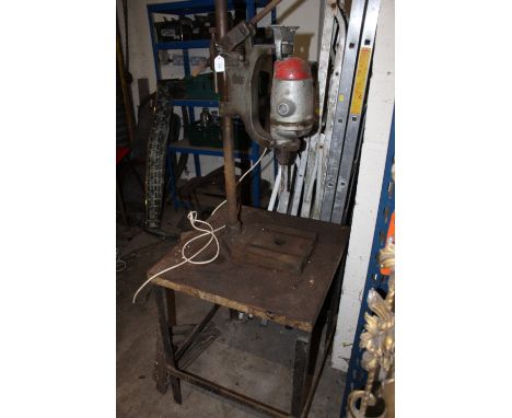 A WOLF PILLAR DRILL PRESS IN A STEEL TABLE, together with two steel wall brackets and  metalwork