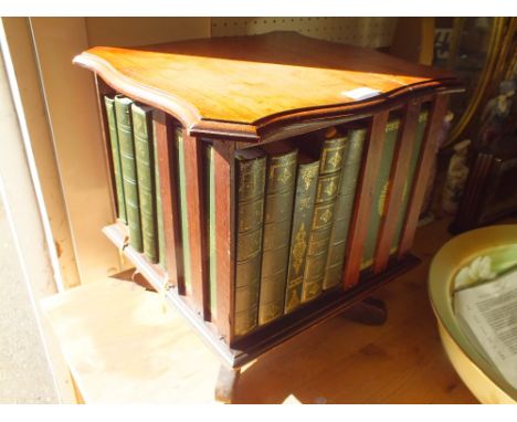 A VINTAGE MAHOGANY TABLETOP ROTATING BOOK RACK AND CONTENTS 