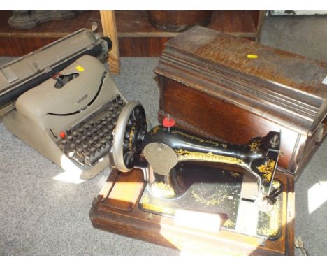 AN OAK CASED VINTAGE SINGER SEWING MACHINE, TOGETHER WITH AN OLIVETTIE LEXICON TYPEWRITER (2) 