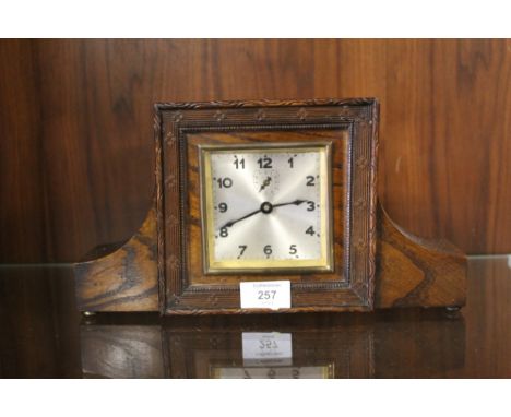 A VINTAGE CARVED OAK MANTEL CLOCK WIDTH - 31CM 