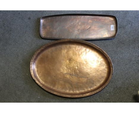 TWO LARGE ARTS AND CRAFTS COPPER TRAYS BY HUGH WALLIS, the larger tray of oval form with central flower and stamped HW, W 55 