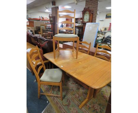 AN ERCOL LIGHT ELM EXTENDING DINING TABLE AND FOUR CHAIRS