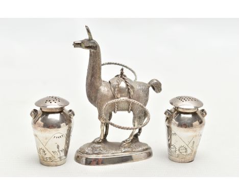 WHITE METAL NOVELTY PEPPPERETTES WITH STAND, the stand in the form of a lama carrying two pots for the salt and pepper pots, 