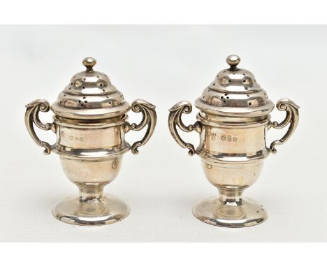 A PAIR OF SILVER PEPPERETTES, each in the form of a trophy cup fitted with double scrolling handles, ball finials to the cove