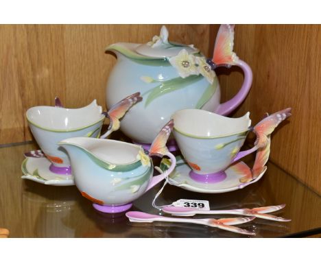 AN EIGHT PIECE FRANZ PORCELAIN PART TEASET, with butterfly handles and moulded flowers, comprising a teapot, a cream jug, two